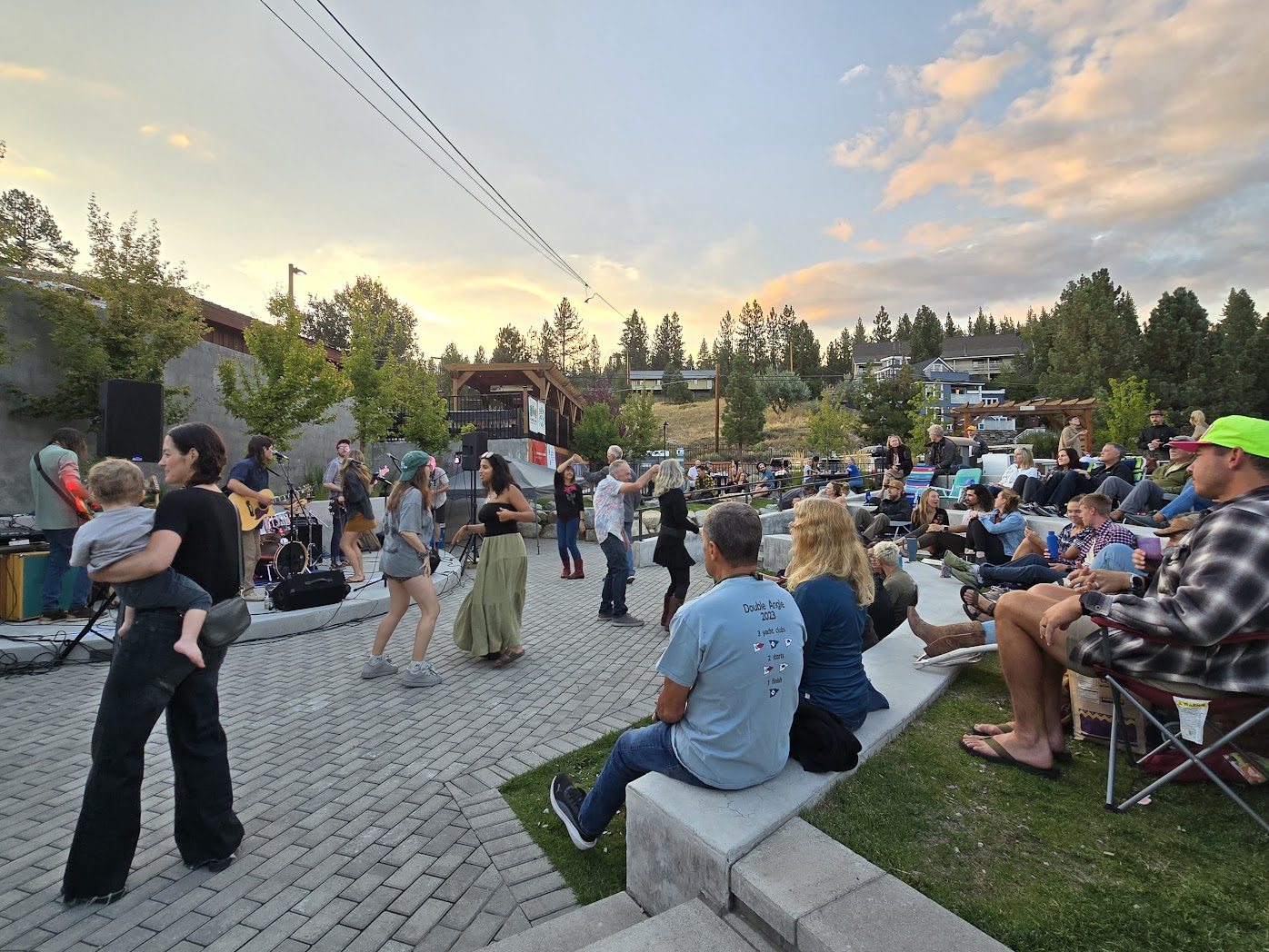 Community members dancing at sunset at Music in the Park in the Truckee Railyard