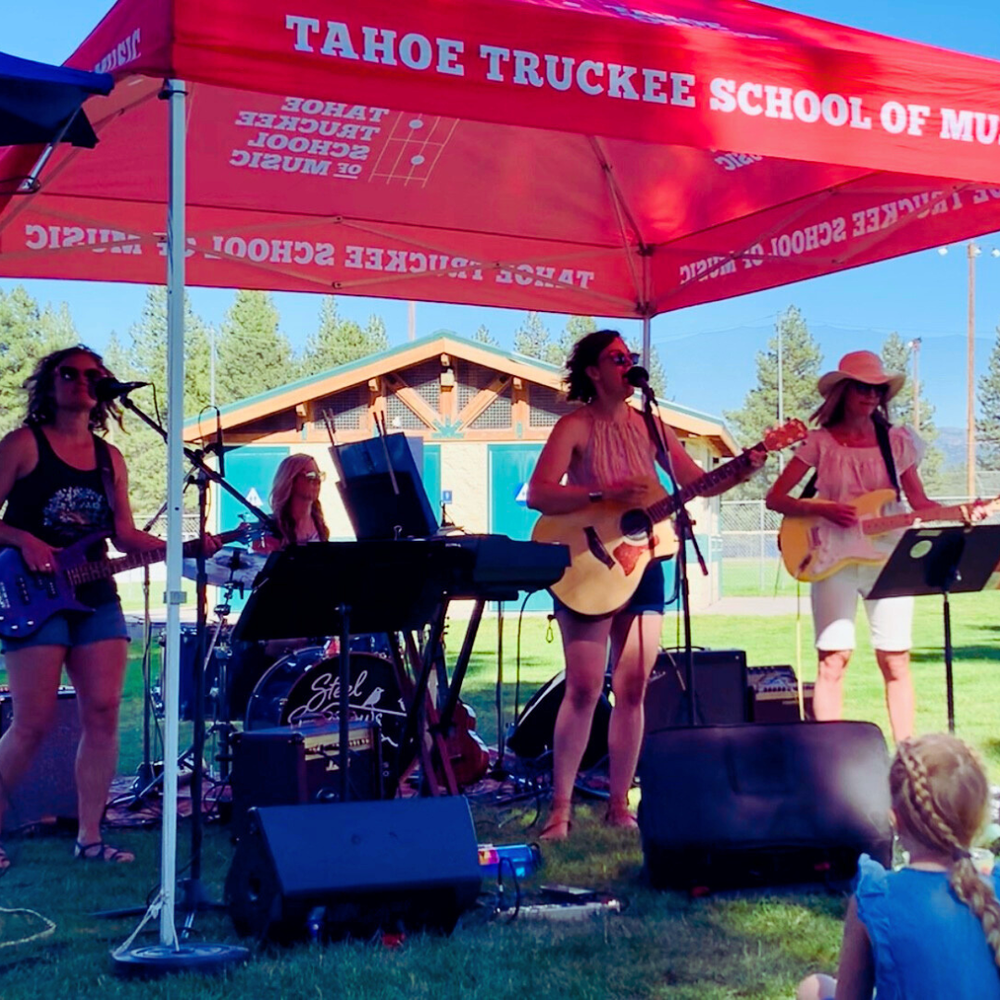 Steel Sparrows band performing outdoors under TTSM tent