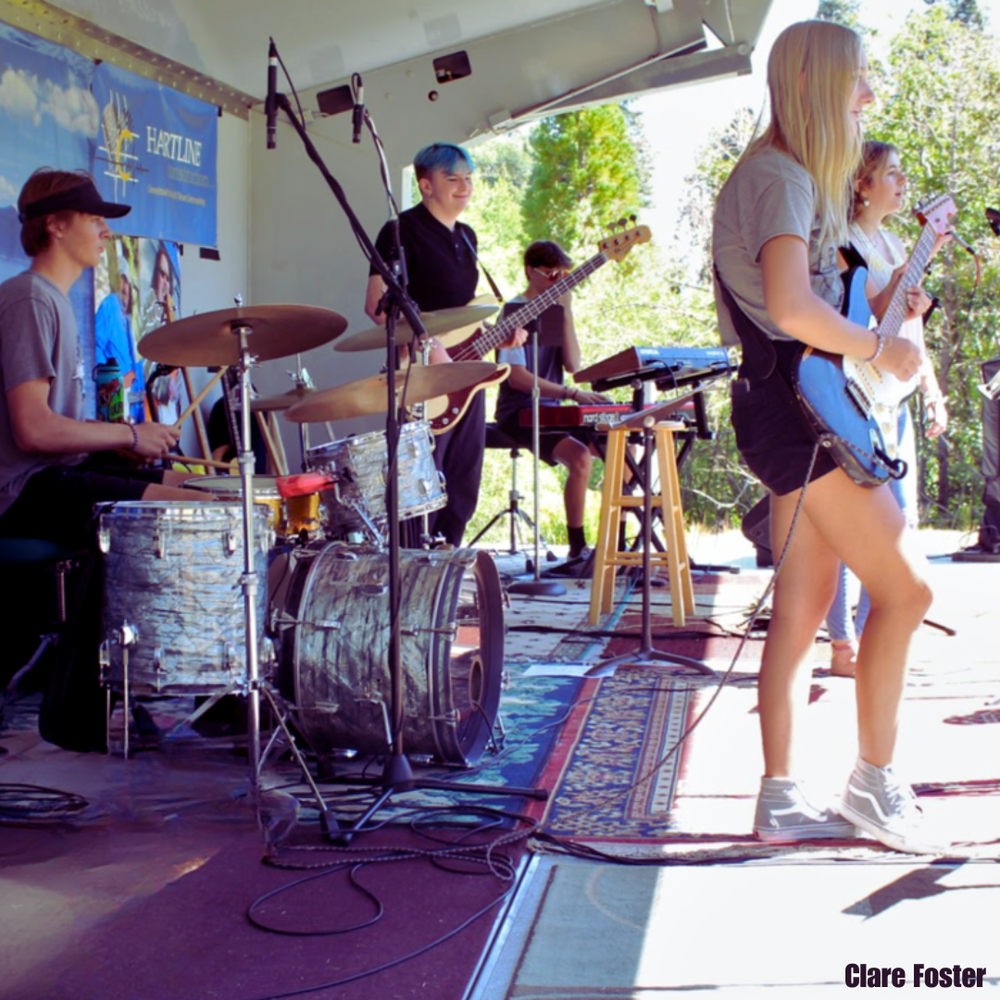 Youth band members working together during outdoor performance