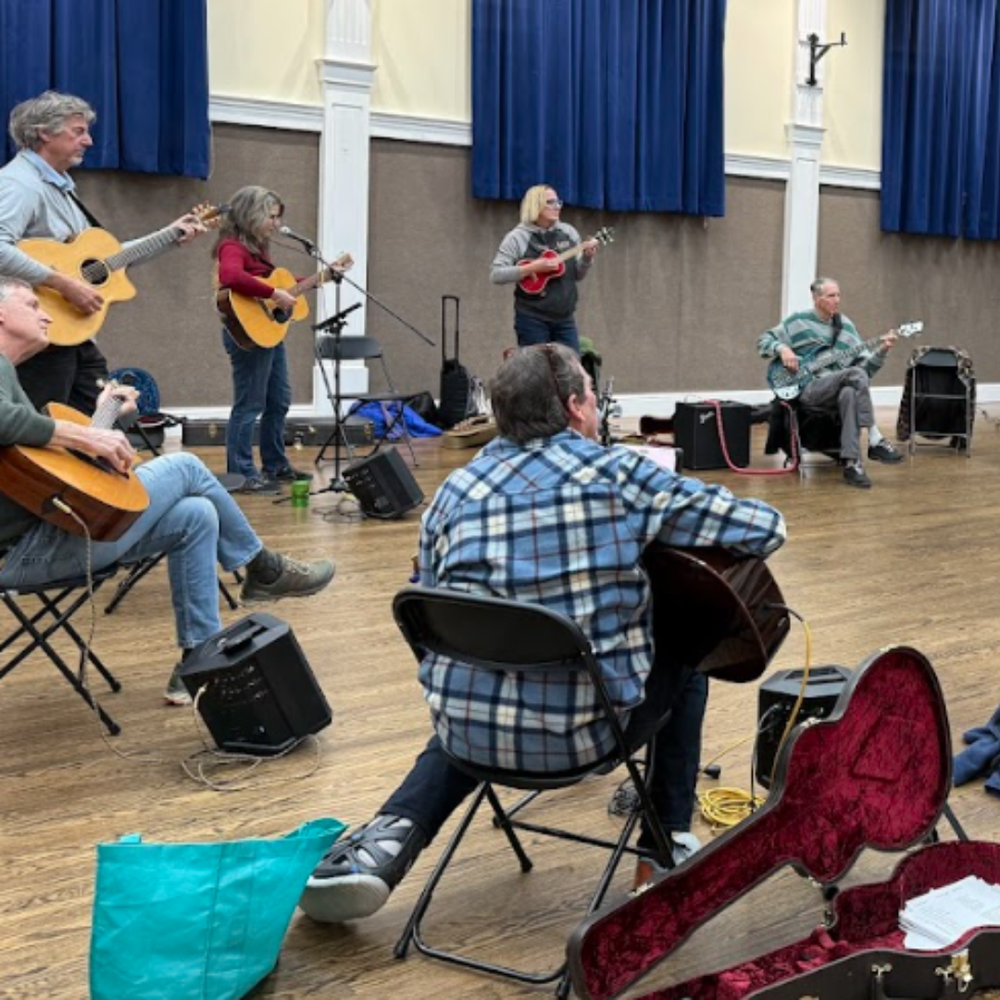 Adults jamming together in a circle at Song Group